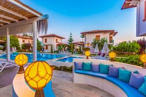 a villa with a swimming pool with a blue couch at Vista Villas in Belek