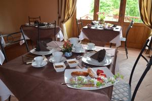 a table with a plate of food on it at Feudo Magazzeni Etna in SantʼAlfio