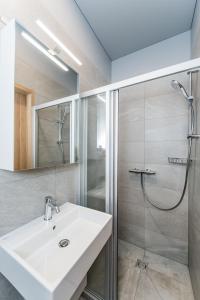 y baño con lavabo y ducha. en River city apartments No 1 by URBAN RENT en Kaunas
