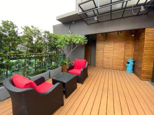a deck with chairs and a table on a building at Royal Rose Hotel Xinsheng in Taipei