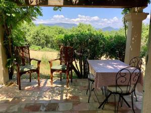 a table and chairs sitting on a patio with a view at Gites De La Galline in La Môle