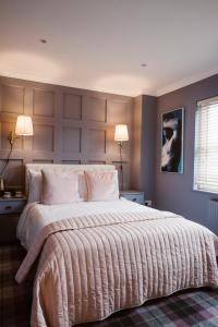 a bedroom with a bed and a lamp at Kilmore Guesthouse in Kilkenny