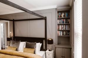 a bedroom with a bed and a book shelf at Kilmore Guesthouse in Kilkenny