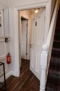 a hallway with a white door and stairs at Kilmore Guesthouse in Kilkenny