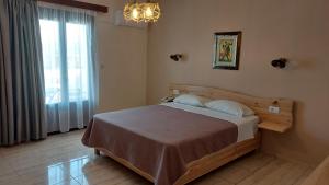 Postel nebo postele na pokoji v ubytování Arkasa Bay Hotel