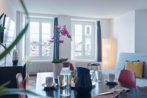 a living room with a table and a couch at HITrental Chapel Bridge Apartments in Luzern