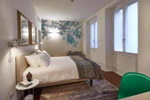 Ein Bett oder Betten in einem Zimmer der Unterkunft Ariosto Social Club