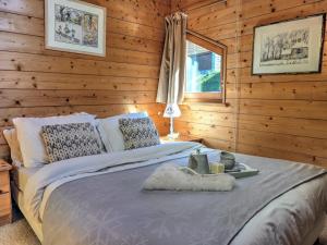a bedroom with a bed in a wooden wall at Chardon Bleu in Peisey-Nancroix
