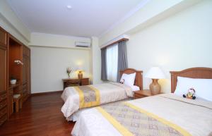 Postel nebo postele na pokoji v ubytování The Sultan Hotel & Residence Jakarta