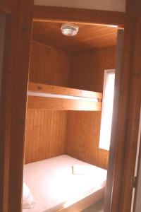 an empty sauna in a wooden cabin with a window at Résidence L'araguina in Bonifacio