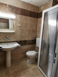 a bathroom with a toilet and a sink and a shower at Hotel Trakia Garden in Sunny Beach