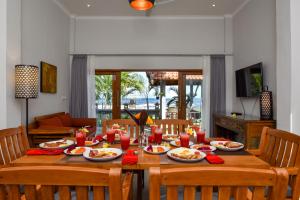 una mesa de comedor con platos de comida. en Villa Spice House Inn Downstair, en Lovina