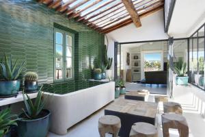 a living room with a tub and some plants at Maison Skyloft in Saint-Tropez