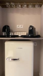 a refrigerator in a kitchen with a counter top at Scarabeo Hotel & Villas Parga in Parga