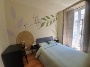 
a bedroom with a bed and a window at Hostel One Ribeira in Porto
