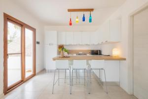 
a kitchen with a table and chairs in it at Surfescape Beachfront Apartments in Kiwengwa
