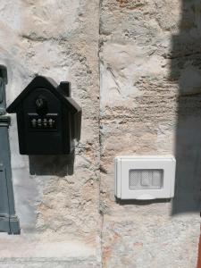 a wall with a box on a stone wall at Home Sweet Home rooms in Bari