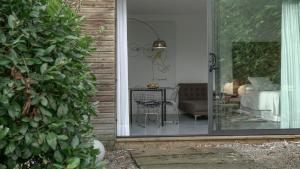 a sliding glass door to a living room with a table at La Posada de Babel in Llanes