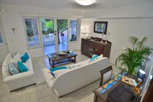 a living room with two couches and a table at *Haritos traditional Apt-5min from Falassarna Bch* in Kissamos
