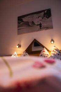 a bedroom with a bed with a picture on the wall at Appartements Romantika & Appartement Barbara in Wagrain