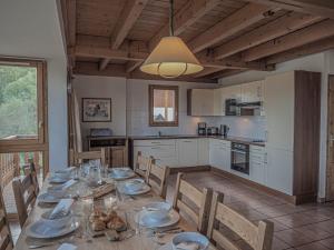 a kitchen with a long table with plates of food at La Belle Maison in Peisey-Nancroix