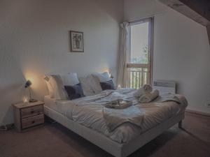 a bedroom with a large bed with a window at La Belle Maison in Peisey-Nancroix