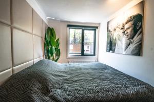 a room with a bed and a painting on the wall at Amsterdam Houseboat amstel in Amsterdam