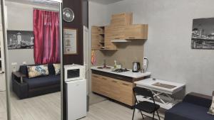 a small kitchen with a counter and a table at Квартира на Дерибасовcкой in Odesa