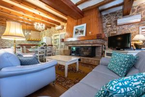 a living room with a couch and a fireplace at Hauzify I Palauet del Remei in Perelló