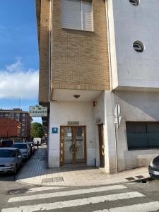 a building with a door on the side of a street at Hotel Camagüey in Gijón