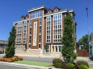 a large brick building on the side of a street at Hotel Crunia I A Coruña in A Coruña