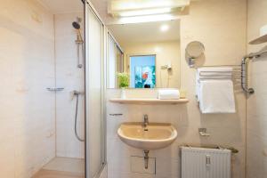 a bathroom with a sink and a shower at W22 Hotel am Kurfürstendamm in Berlin