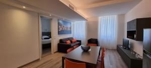 a living room with a couch and a table in a room at RivAppartamenti in Riva del Garda