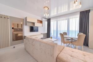 a living room with a couch and a table at AZIMUTH Hotel by Building Stefan - Hotel Building Stefan Resort I Sud in Mamaia Sat/Năvodari