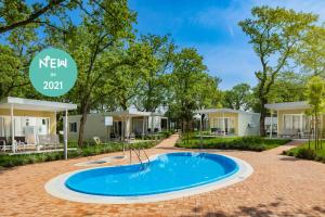 a swimming pool at a resort with modular homes at Camping Ulika Mobile Homes - Naturist in Poreč