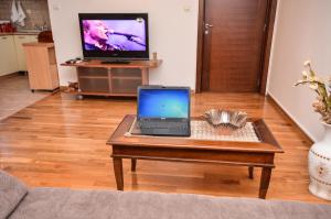 a laptop sitting on a coffee table in a living room at Apartments Petkovic Budva in Budva