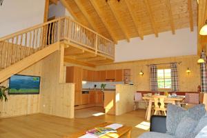 a large living room with a staircase and a kitchen at Ferienhaus Johanna in Schladming