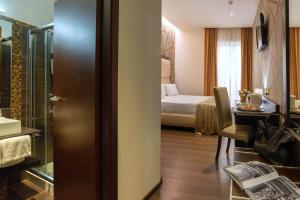 Postel nebo postele na pokoji v ubytování Catone District Hotel