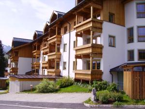 a building with wooden balconies on the side of it at Appartement Königsleiten in Königsleiten