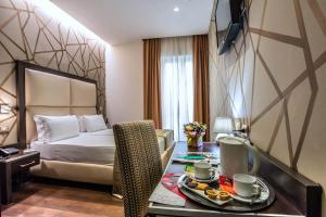 Postel nebo postele na pokoji v ubytování Catone District Hotel