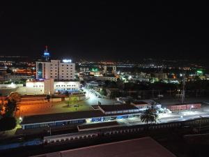 a view of a city at night with a train at Mirador Palace Hôtel in Chlef