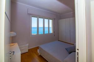 Posteľ alebo postele v izbe v ubytovaní Casa Baia Blu