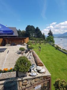 a view of a backyard with a garden and the water at Drevenica MARKA beachfront cottage in Liptovský Trnovec