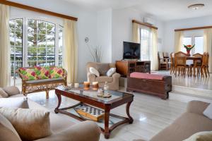 a living room with a couch and a coffee table at Sunset Home with sea view in Chania Town