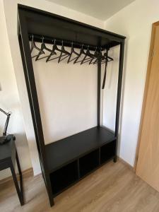 a black closet with a black shelf in a room at Ferienwohnung Am Jacobsweg Wohnung 1 in Wurzen