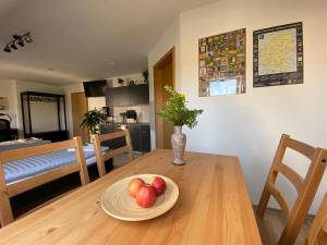 a table with a plate of apples on top of it at Ferienwohnung Am Jacobsweg in Wurzen