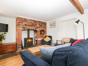 a living room with a couch and a fireplace at 40 The Ridgeway in Weymouth