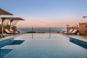 a swimming pool with a view of the ocean at Emerald Villas & Suites - The Finest Hotels Of The World in Agios Nikolaos