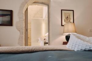 1 dormitorio con cama y espejo grande en 1783 Dimora d'Epoca, en Locorotondo
