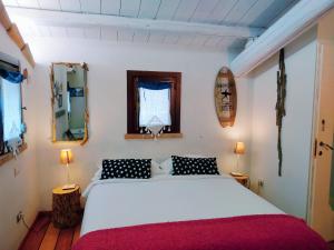 a bedroom with a large white bed and two lamps at Ca' Barbona in Lido di Classe